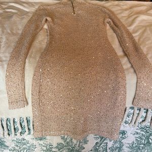 Sequin-accented cream-colored sweater dress.